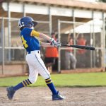 Youth baseball batter swinging